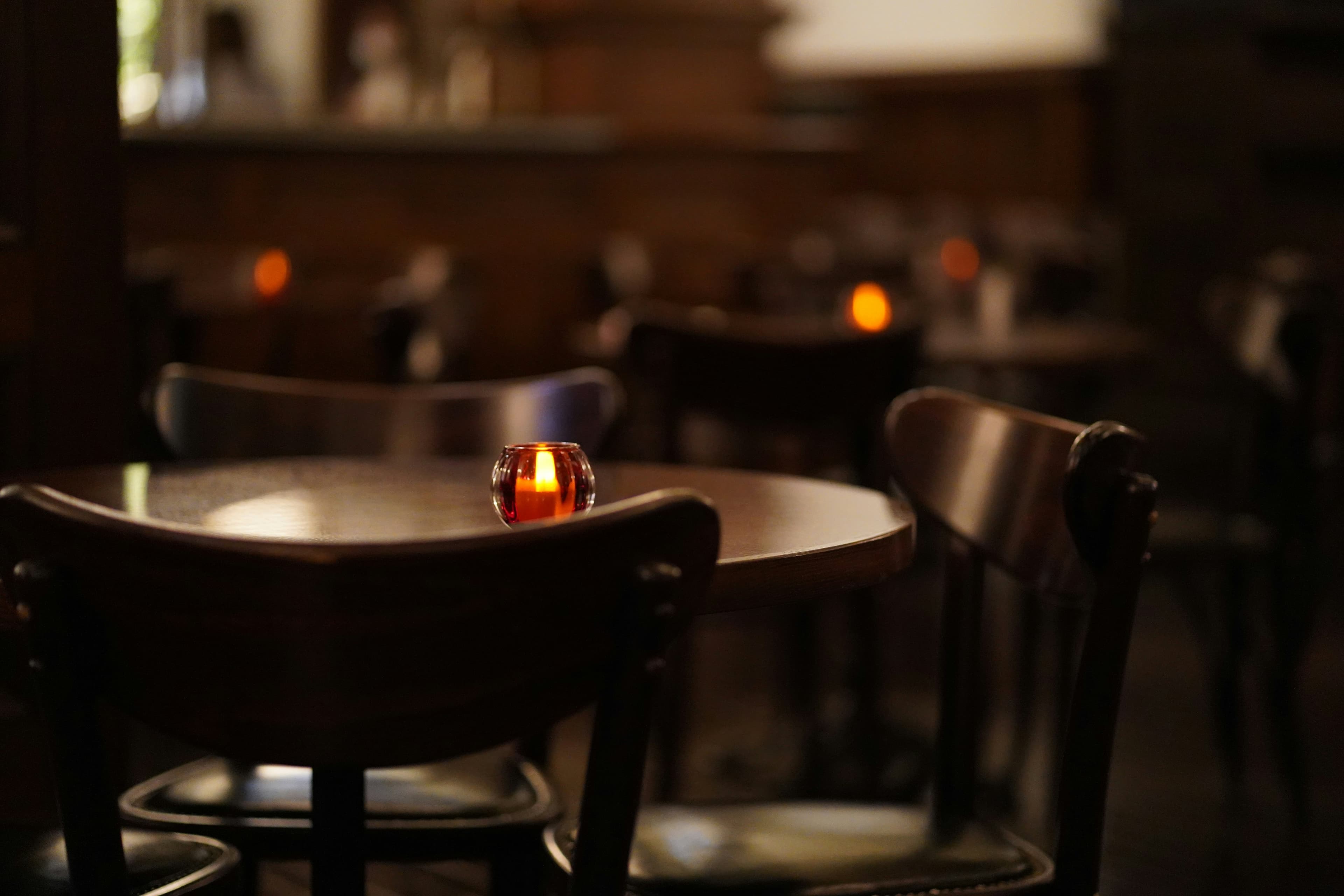 A single flame on an empty table after service