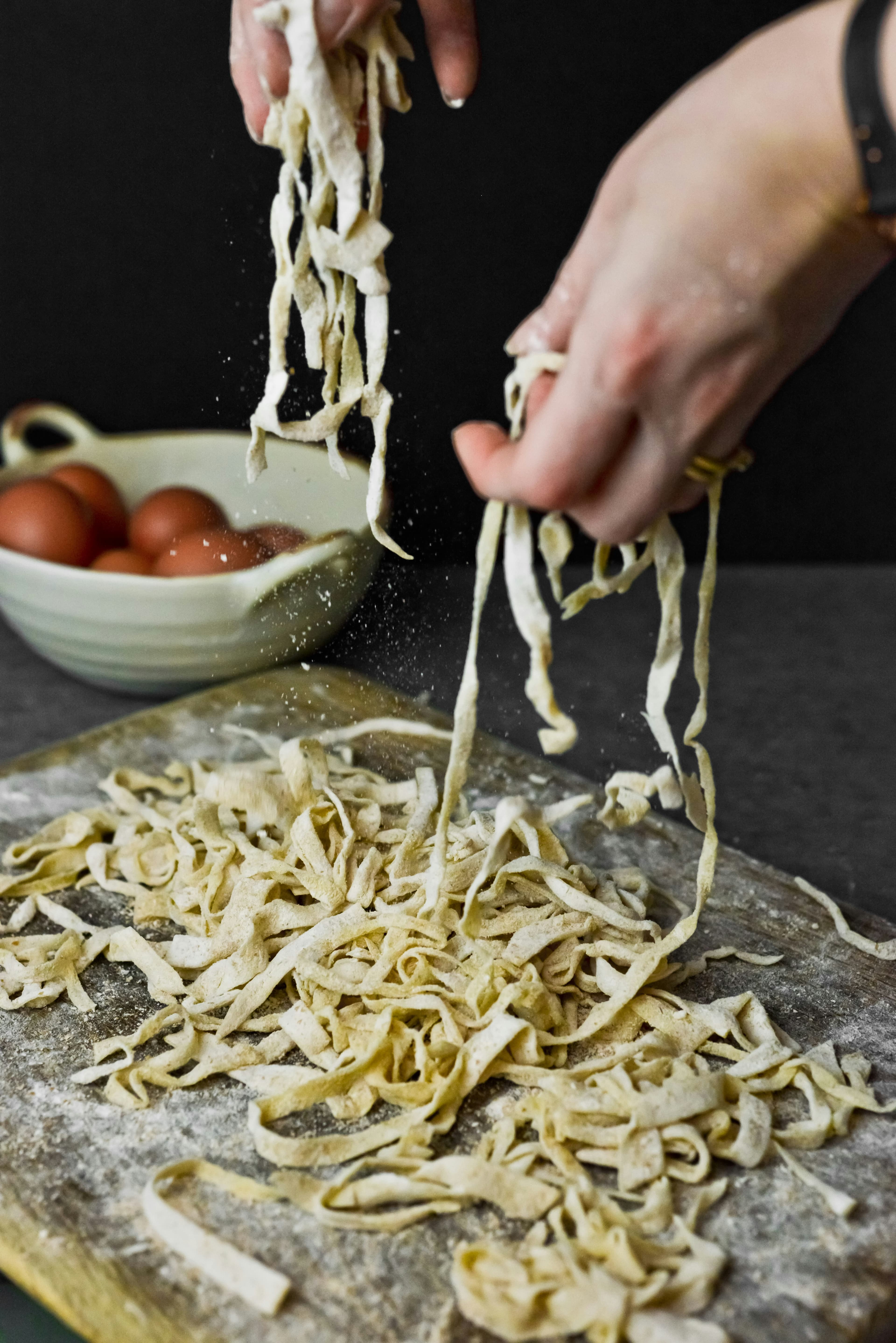 Ribbons of tagliatelle draped over a wooden rack