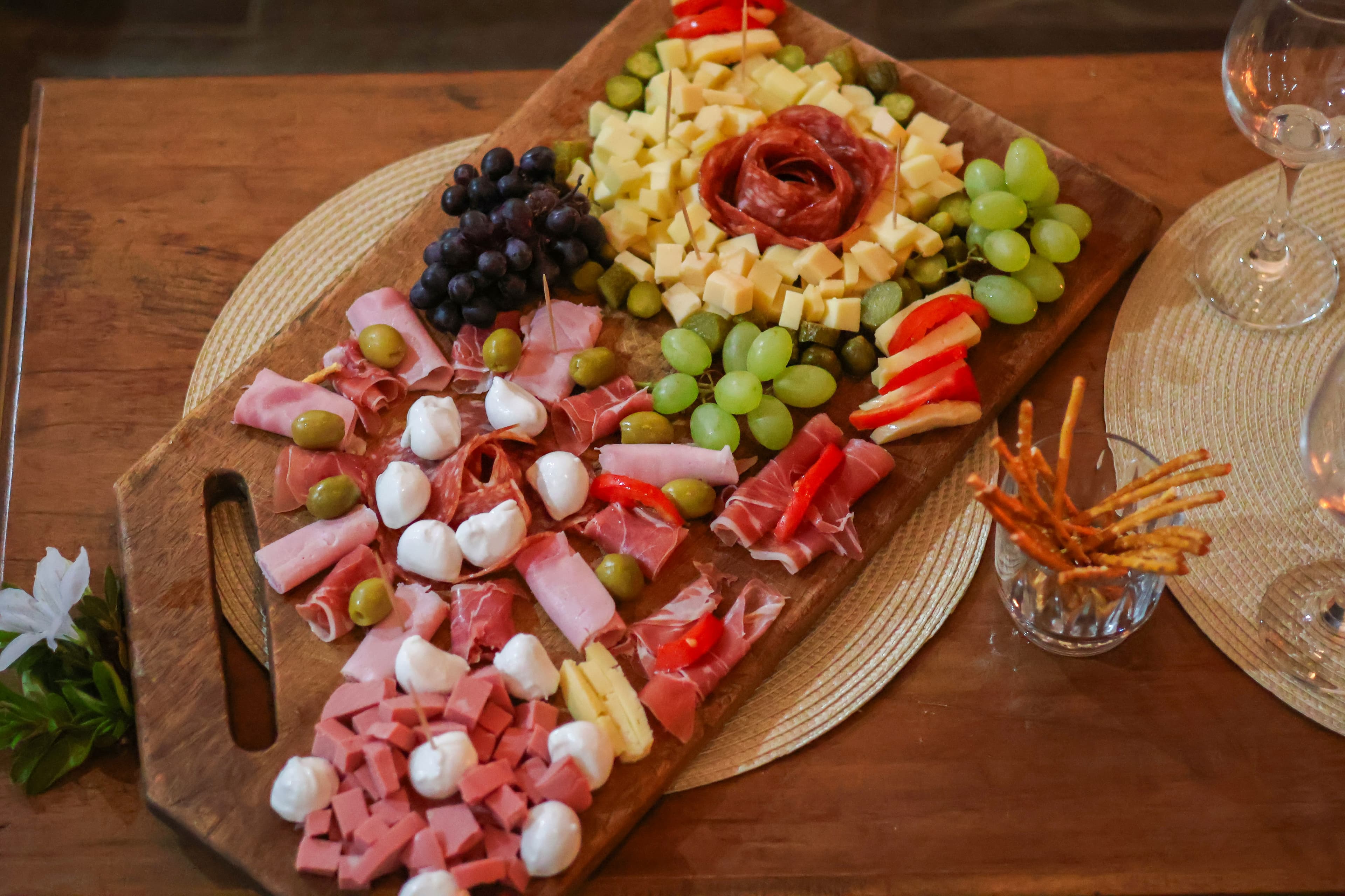 Rustic Italian table with meats, cheese, and wine