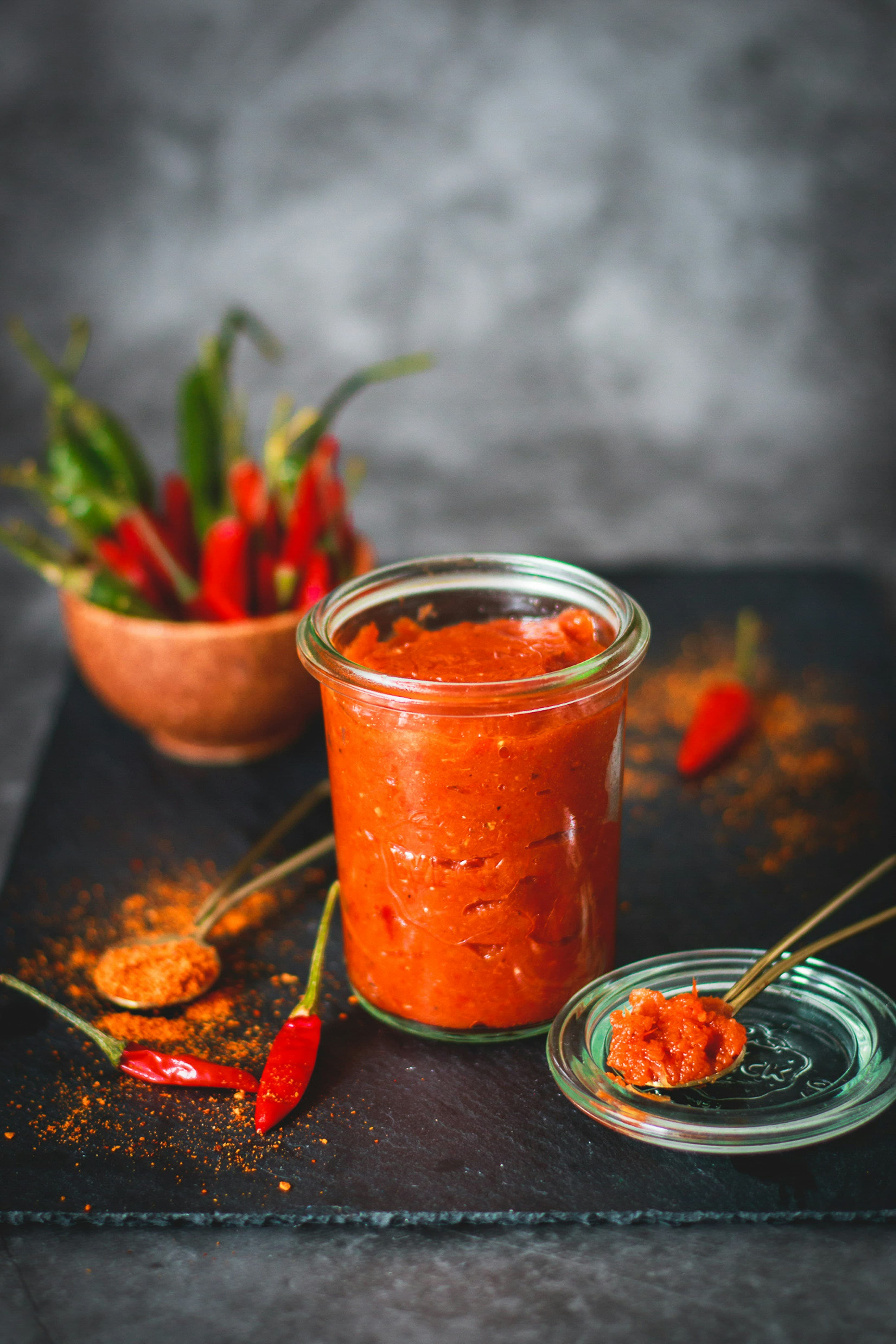 Sauce spooned slowly over fresh noodles