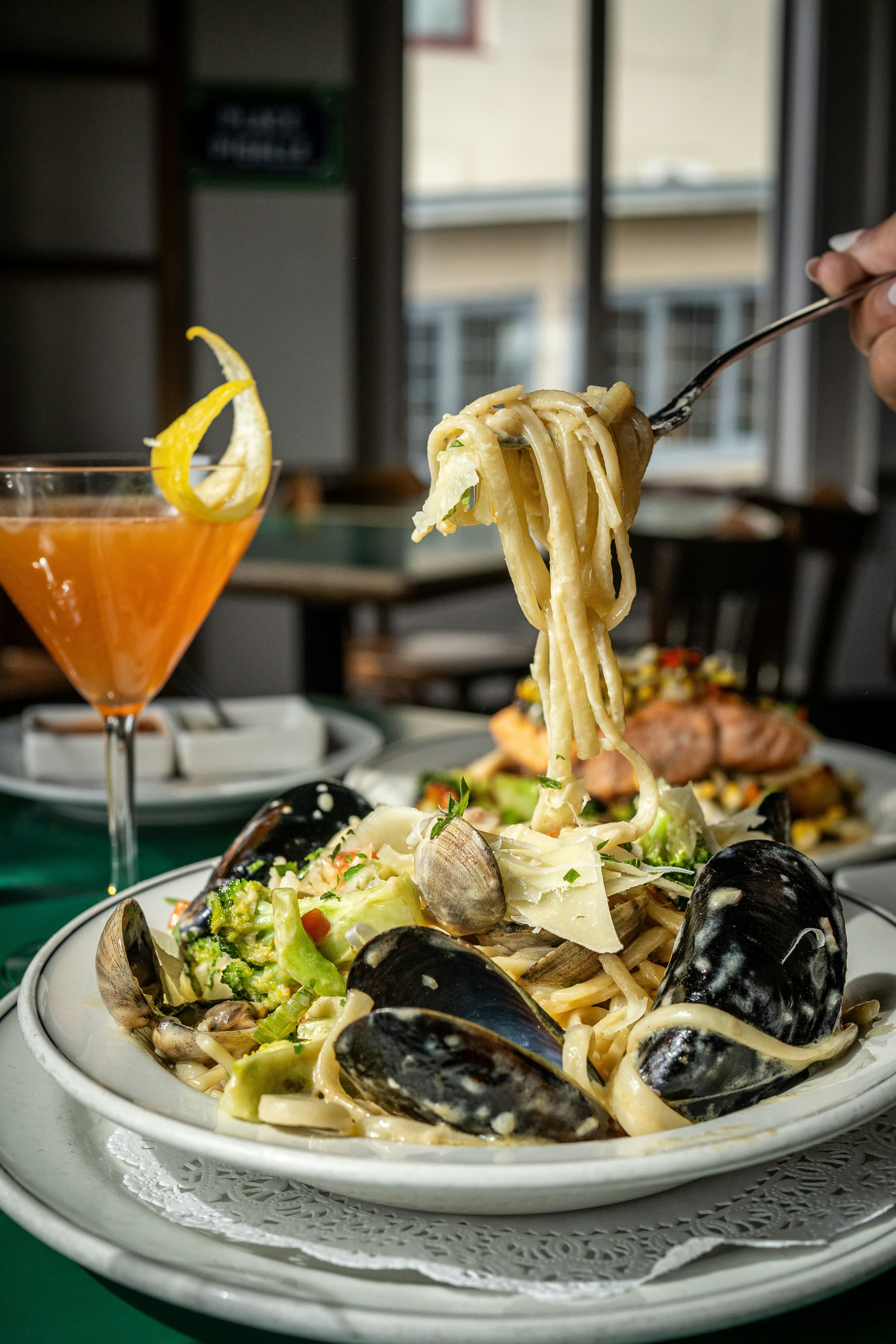 Clams opened over pasta and parsley