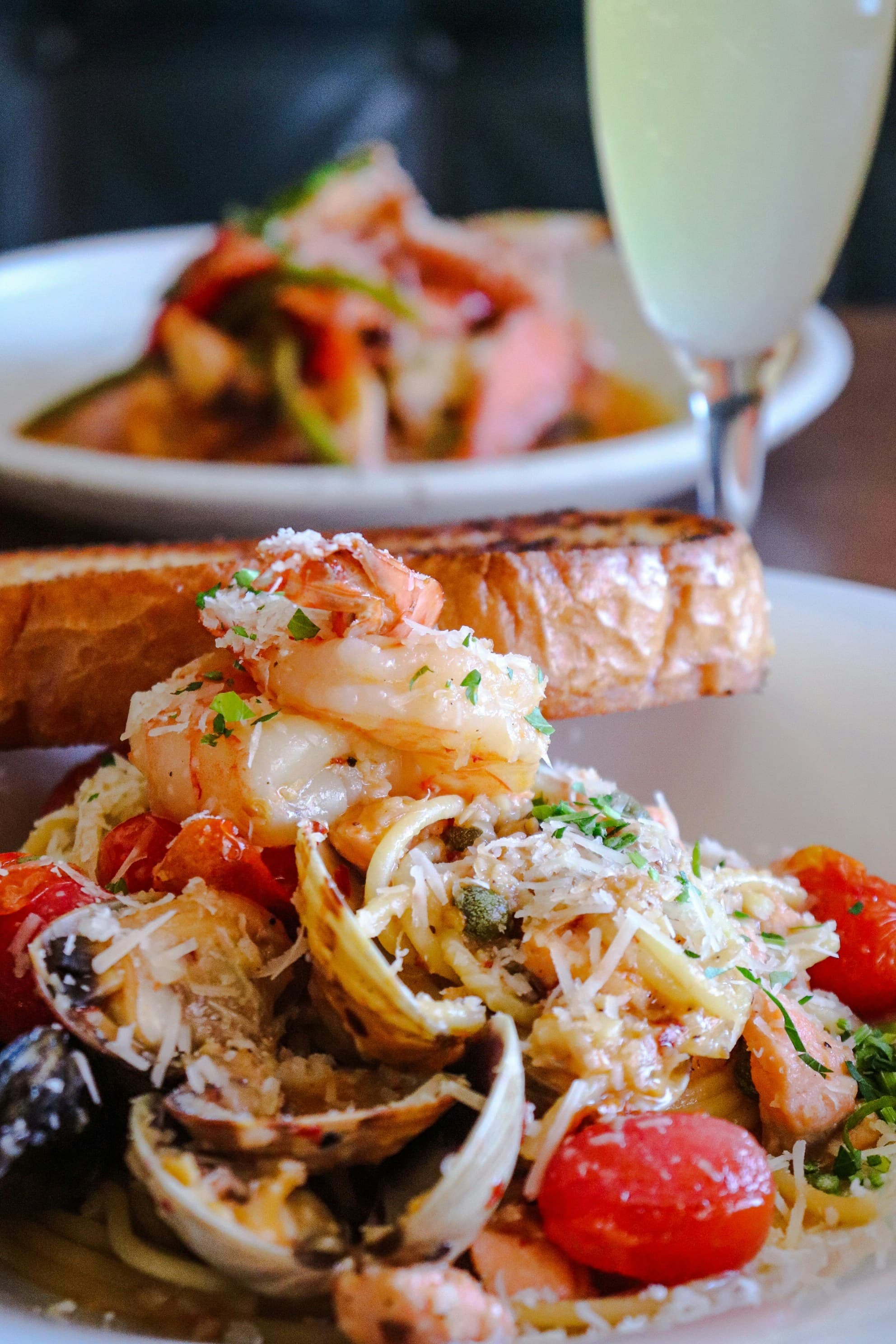A bowl of seafood pasta set down at the table