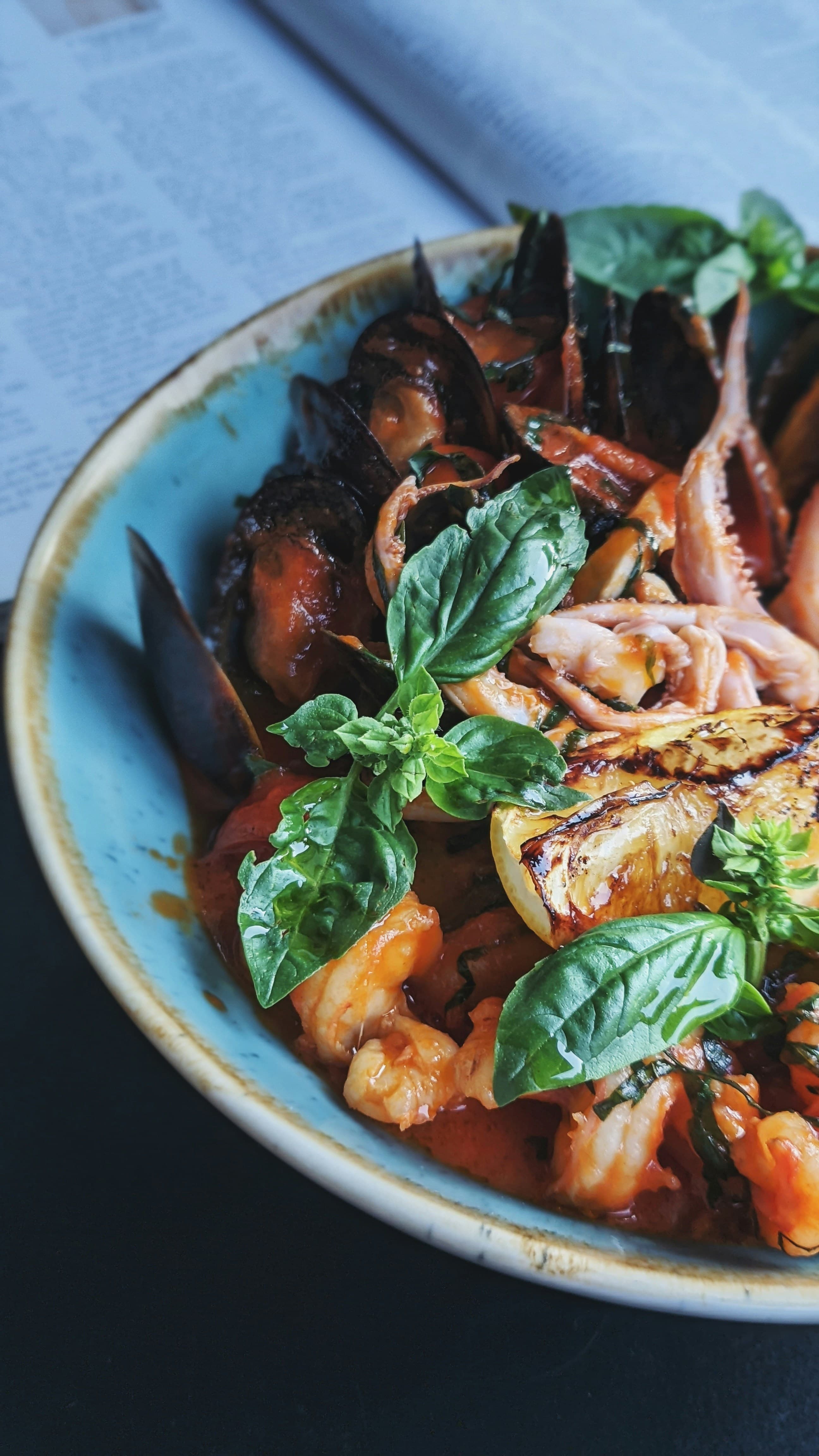 A tall plate of seafood pasta from above