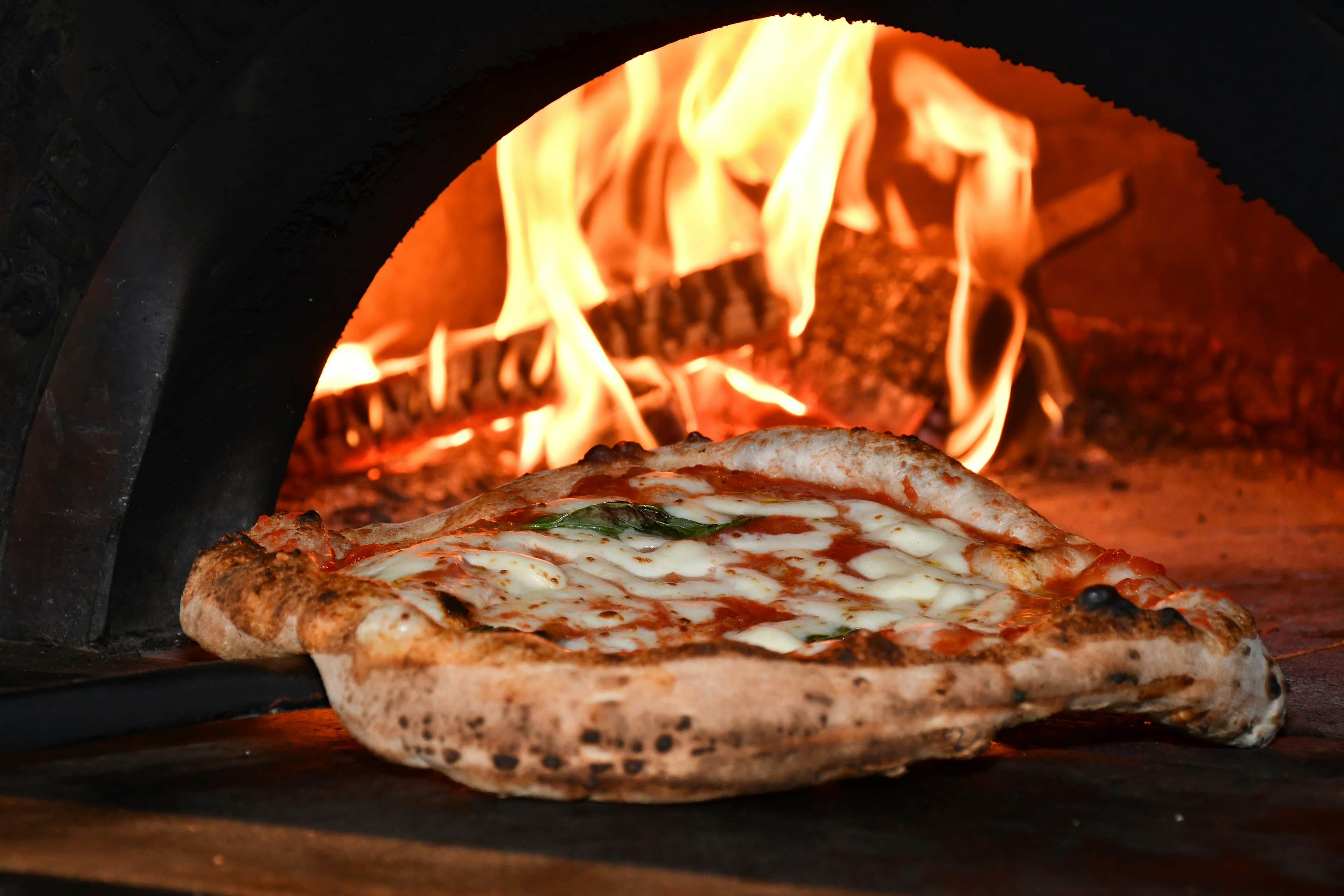 Margherita baking in the wood-fired oven