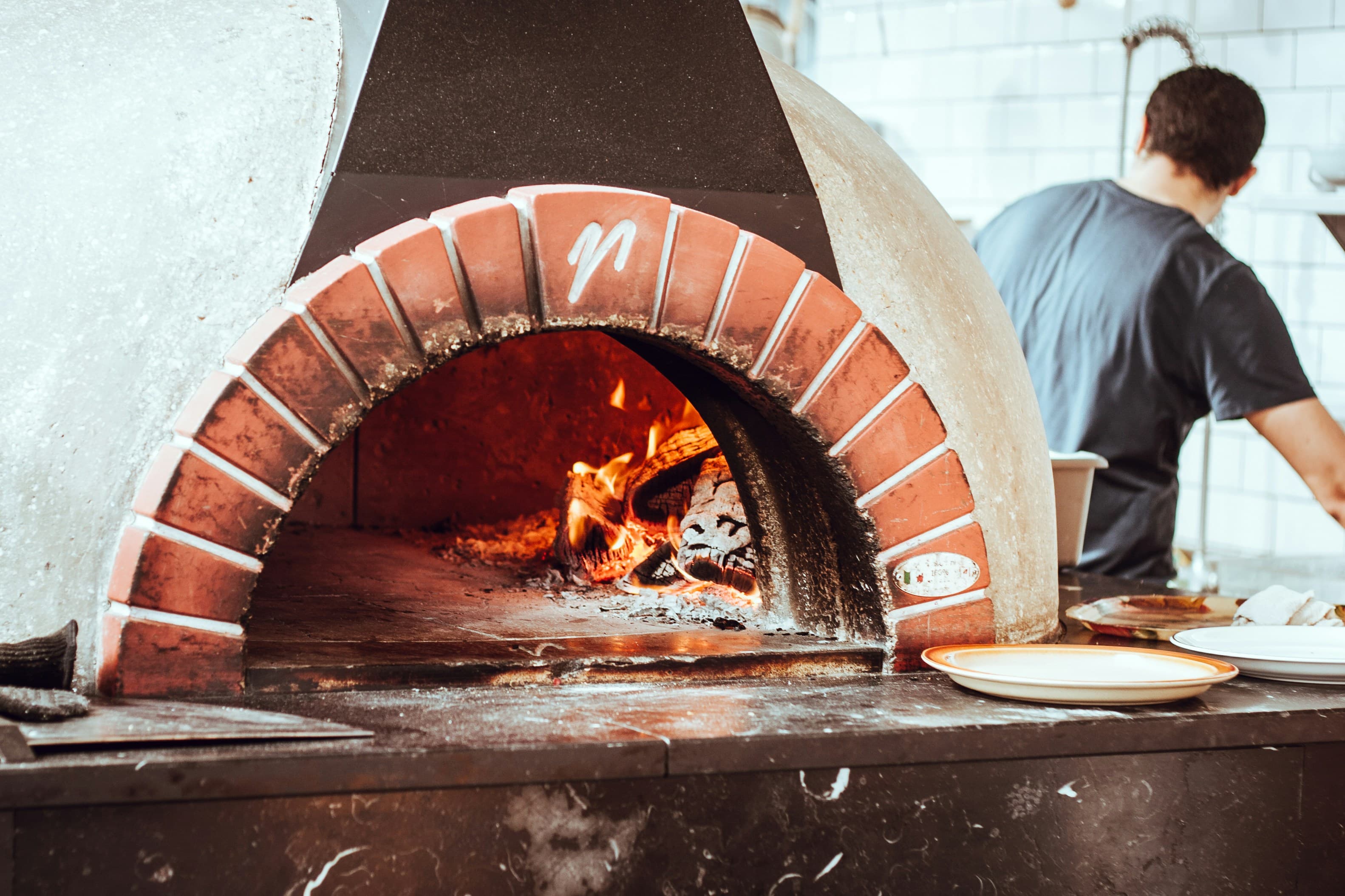 Flame curling around the oven mouth
